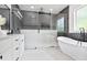 Modern bathroom showcases a glass-enclosed shower, a soaking tub, and a sleek vanity at 73 Whitefoord Se Ave, Atlanta, GA 30317