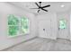 Cozy bedroom with neutral carpet, large window, ceiling fan, and an adjacent closet and door at 73 Whitefoord Se Ave, Atlanta, GA 30317