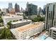 Aerial view capturing the building's urban setting and pool with ample lounge seating at 1421 Peachtree Ne St # 203, Atlanta, GA 30309