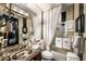 Elegant bathroom featuring granite countertop sink, coordinated towels, and tiled shower for a spa-like experience at 1421 Peachtree Ne St # 203, Atlanta, GA 30309