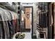 Spacious closet featuring clothes, hats and shoes, and a view into hallway at 1421 Peachtree Ne St # 203, Atlanta, GA 30309