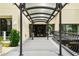 Building entrance features an awning, black metal railings and lush landscaping at 1421 Peachtree Ne St # 203, Atlanta, GA 30309