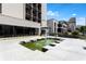 Exterior view of a condominium complex with water features, seating, and meticulous landscaping at 1421 Peachtree Ne St # 203, Atlanta, GA 30309