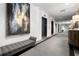 Hallway view featuring elevator access, modern artwork, and a seating area for residents at 1421 Peachtree Ne St # 203, Atlanta, GA 30309