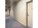 Hallway view featuring neutral walls and carpet leading to residential doors at 1421 Peachtree Ne St # 203, Atlanta, GA 30309