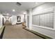 Well-lit hallway with mailboxes, seating, and carpet flooring with dark trim at 1421 Peachtree Ne St # 203, Atlanta, GA 30309