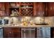 Kitchenette view of stainless steel appliances, granite countertops, and dark wood cabinetry at 1421 Peachtree Ne St # 203, Atlanta, GA 30309
