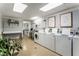 Community laundry room with multiple washing machines and dryers at 1421 Peachtree Ne St # 203, Atlanta, GA 30309