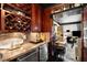 Living room and wet bar area with wine storage, granite countertop and hardwood floors at 1421 Peachtree Ne St # 203, Atlanta, GA 30309