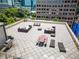 Wide angle rooftop view featuring multiple seating arrangements, a grill, and a dining area at 1421 Peachtree Ne St # 203, Atlanta, GA 30309