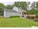 View of backyard features a large deck and expansive lawn of a two-story home at 1492 Harbins Rd, Norcross, GA 30093