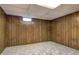 Carpeted basement area with paneled walls and small window at 1492 Harbins Rd, Norcross, GA 30093