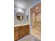 Full bathroom with wood cabinets, carpeted floors, and a glass shower at 1492 Harbins Rd, Norcross, GA 30093