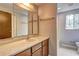 Bathroom with wooden cabinets and a large mirror above the sink at 1492 Harbins Rd, Norcross, GA 30093