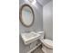 Powder room featuring a decorative mirror and pedestal sink at 1492 Harbins Rd, Norcross, GA 30093