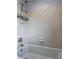 Neutral bathroom featuring a tub with shower head and tile at 1492 Harbins Rd, Norcross, GA 30093