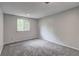This is a gray bedroom with natural light and carpet at 1492 Harbins Rd, Norcross, GA 30093