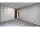 A bedroom with neutral carpet, paint, and a large closet at 1492 Harbins Rd, Norcross, GA 30093