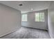 Neutral finished room with carpet and a large window at 1492 Harbins Rd, Norcross, GA 30093