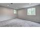 Neutral finished room with carpet and a large window at 1492 Harbins Rd, Norcross, GA 30093