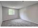 Neutral finished room with carpet and a large window at 1492 Harbins Rd, Norcross, GA 30093