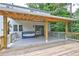 The spacious outdoor deck is covered with a beam and features a swinging sofa at 1492 Harbins Rd, Norcross, GA 30093