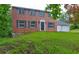 Traditional brick home with a two-car garage and blue door at 1492 Harbins Rd, Norcross, GA 30093