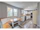 Bright kitchen featuring white cabinets, laminate countertops, and a cozy breakfast nook at 1492 Harbins Rd, Norcross, GA 30093