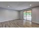 Open living room featuring hardwood floors and sliding doors to outdoor living space at 1492 Harbins Rd, Norcross, GA 30093