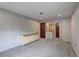 Finished room with carpet and view of doorways and stairs in the corner at 1492 Harbins Rd, Norcross, GA 30093
