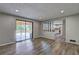 Open living room with sliding glass doors leading to a deck and a view into the kitchen area at 1492 Harbins Rd, Norcross, GA 30093