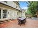 Charming backyard patio with brick pavers, an outdoor dining set, and a landscaped garden at 3251 Pinestream Nw Rd, Atlanta, GA 30327