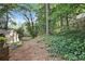 View of the backyard with a sloping landscape and lush greenery at 3251 Pinestream Nw Rd, Atlanta, GA 30327