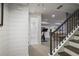 Finished basement with shiplap walls, view to bathroom, and a staircase at 3251 Pinestream Nw Rd, Atlanta, GA 30327