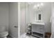 White subway tile shower with a glass enclosure, gray vanity and toilet at 3251 Pinestream Nw Rd, Atlanta, GA 30327