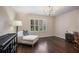 Bedroom featuring hardwood floors, shuttered windows, and neutral decor at 3251 Pinestream Nw Rd, Atlanta, GA 30327