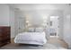 Bedroom suite with adjoining bathroom, tufted headboard and neutral decor at 3251 Pinestream Nw Rd, Atlanta, GA 30327