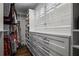 Walk-in closet with custom shelving, drawers, and ample storage space, plus white shuttered windows at 3251 Pinestream Nw Rd, Atlanta, GA 30327
