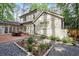 Back exterior view of home with brick accents, patio, and gravel area at 3251 Pinestream Nw Rd, Atlanta, GA 30327