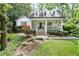 Charming two-story home with a welcoming front porch and lush landscaping at 3251 Pinestream Nw Rd, Atlanta, GA 30327
