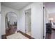 Hallway with hardwood floors, opening to a dining area and doorway to a bright bathroom at 3251 Pinestream Nw Rd, Atlanta, GA 30327