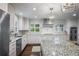 Well-lit kitchen boasts updated stainless appliances, granite counters, and ample white cabinetry at 3251 Pinestream Nw Rd, Atlanta, GA 30327