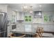 Beautiful kitchen with large island, stainless appliances, granite counters, and modern lighting at 3251 Pinestream Nw Rd, Atlanta, GA 30327