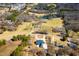 Wide aerial shot of a property, showcasing the house, pond, and surrounding countryside at 111 Dixson Rd, Bowdon, GA 30108