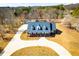 Areal view of charming brick home, showcasing the expansive driveway and inviting curb appeal at 111 Dixson Rd, Bowdon, GA 30108