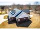 Aerial view of a brick home with a long driveway and well-maintained landscaping at 111 Dixson Rd, Bowdon, GA 30108