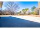 Large backyard featuring lush trees, a well-manicured lawn, and spacious patio perfect for outdoor activities at 111 Dixson Rd, Bowdon, GA 30108