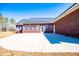 Exterior view of brick home featuring a spacious patio perfect for entertaining and relaxing outdoors at 111 Dixson Rd, Bowdon, GA 30108