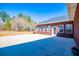 Exterior of brick home with a large patio, lawn, and abundant natural light at 111 Dixson Rd, Bowdon, GA 30108