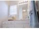 Bright bathroom featuring white cabinets, gold hardware, decorative accents and natural lighting at 111 Dixson Rd, Bowdon, GA 30108